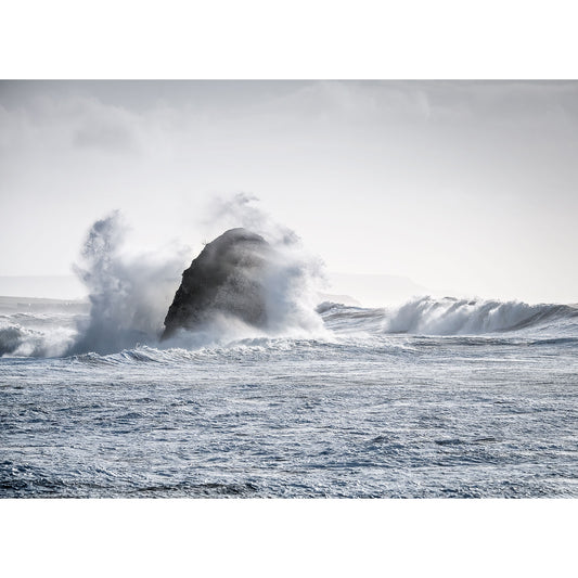 Large ocean waves crash against a solitary rock under a cloudy sky in "Freshwater Bay" by Available Light Photography, sending dramatic splashes and spray across the foreground.