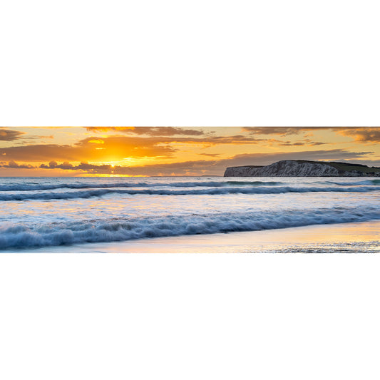 Sunset over the ocean with waves reaching the shore near Compton Bay and clouds scattered across the sky by Available Light Photography.