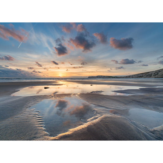 Sunset over Compton Bay on the Isle of Wight with reflective tidal pools and a dynamic sky by Available Light Photography.