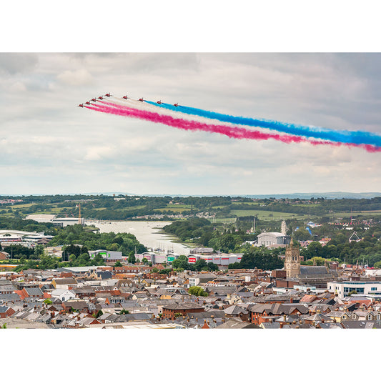 A squadron of The Red Arrows jets flying in formation over a city, trailing colored smoke, led by the renowned pilot Steve Gascoigne.