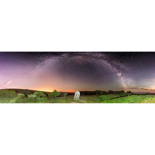A panoramic view of the Milky Way arching across the night sky above a solitary observer in a rural landscape on the Isle. - A panoramic view of The Longstone arching across the night sky above a solitary observer in a rural landscape on the Isle by Available Light Photography.