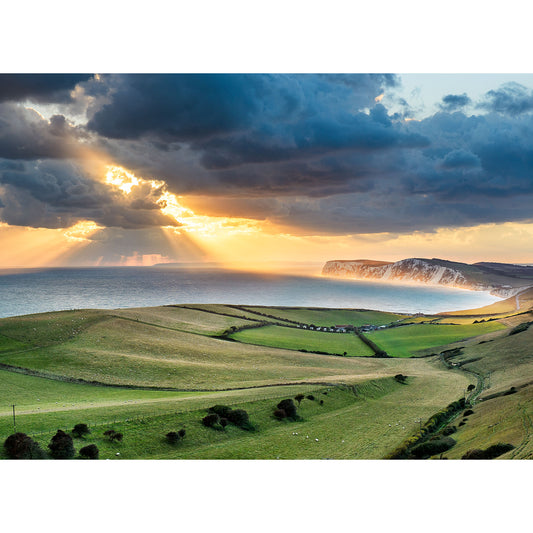 Sunbeams shining through clouds over a rolling coastal landscape on the Isle of Wight at sunset, captured in "Looking toward Tennyson Down" by Available Light Photography.
