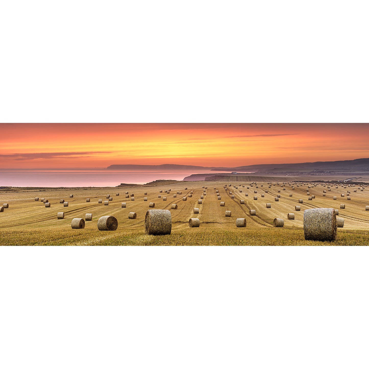Sunset over a coastal farmland on the Isle, dotted with straw bales from Chale by Available Light Photography.