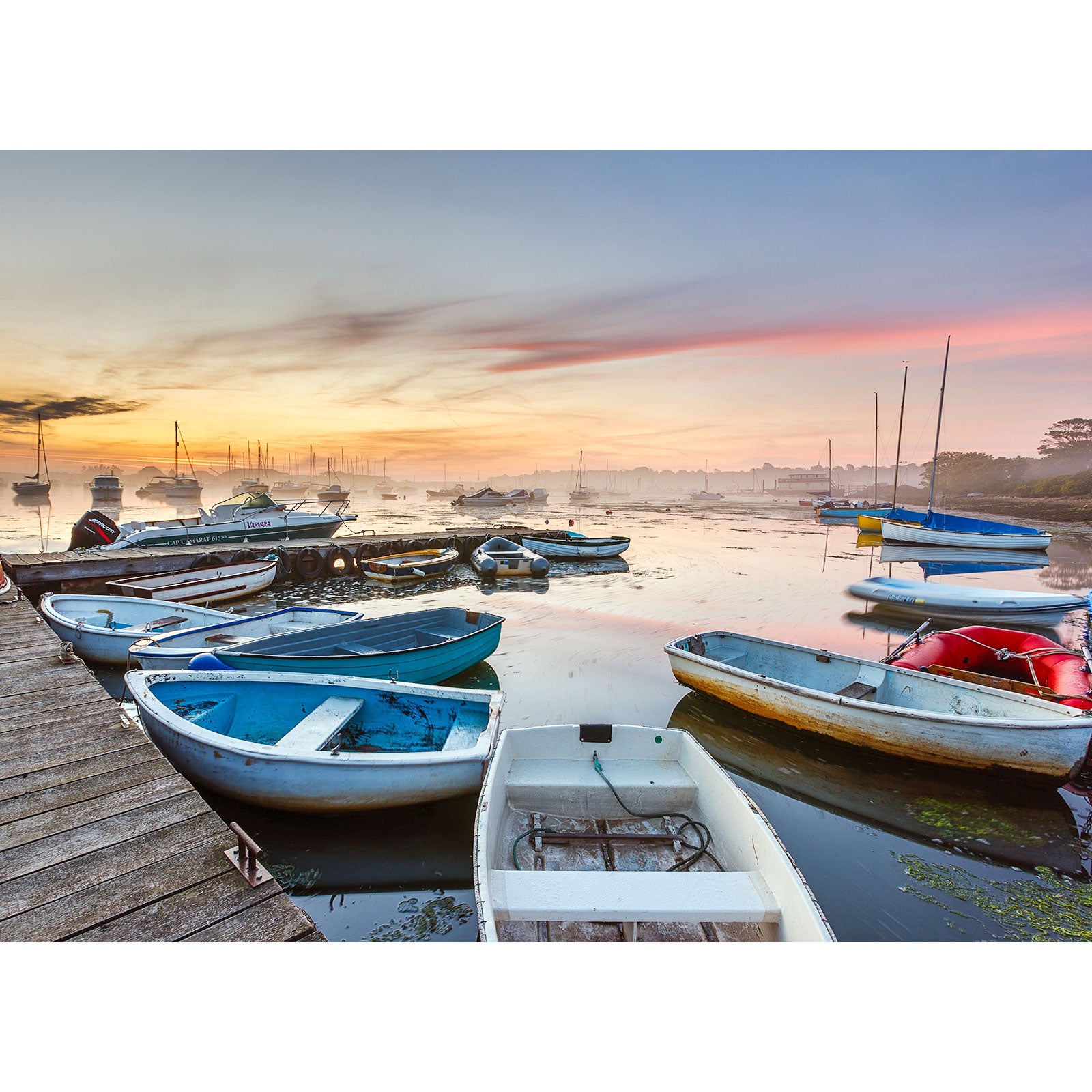 Boats moored at Bembridge Harbour on the Isle of Wight during a colorful sunrise, captured by Available Light Photography.