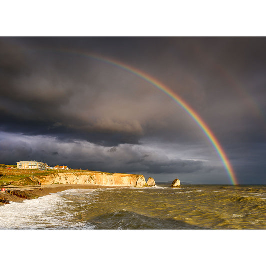 A vibrant Rainbow arcs over a stormy sea near the Gascoigne-cliff-lined coast of the Isle of Wight, captured by Available Light Photography at Freshwater Bay.