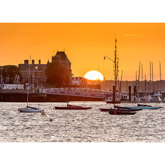 Sunset over Cowes by Available Light Photography, with boats and historical buildings on the Isle of Wight in the background.