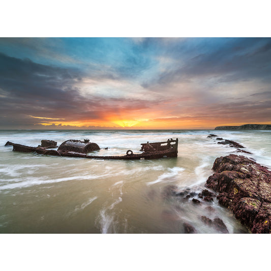 Sunset over a shipwreck on the rocky shoreline of the Isle of Wight captured by SS Carbon from Compton Bay by Available Light Photography.