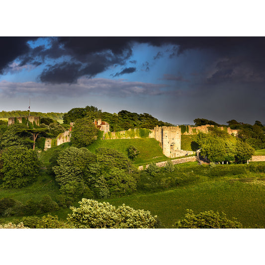 Historic castle surrounded by greenery under a dramatic cloudscape, evoking the legendary tales of Storm over Carisbrooke Castle by Available Light Photography.