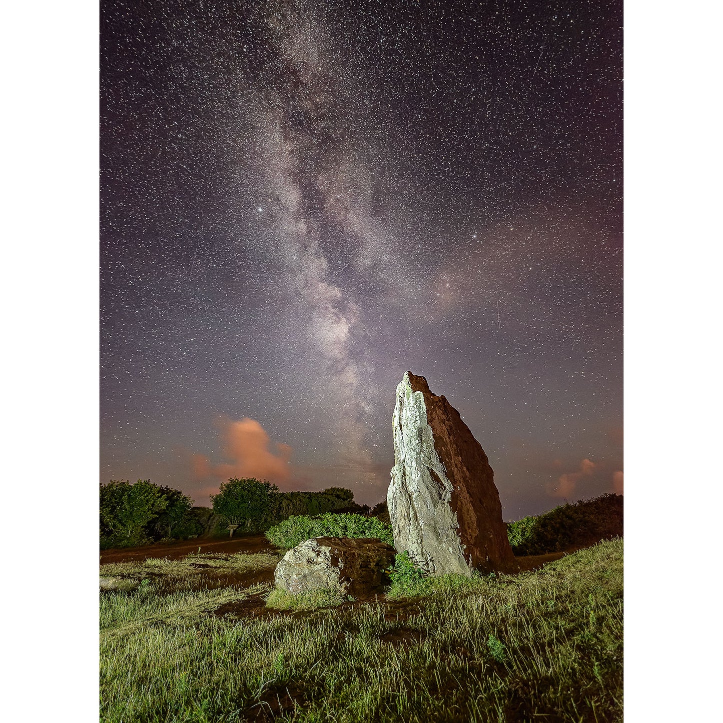 A standing stone on the Isle of Wight under a starry night sky with the Milky Way visible, captured by Available Light Photography's The Longstone.