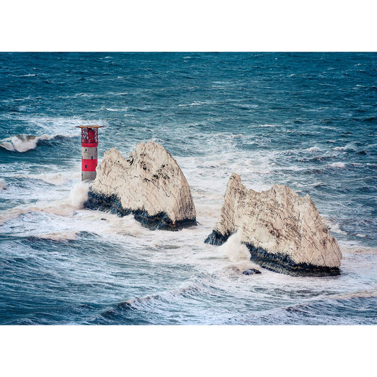 Lighthouse on rocky islets amidst turbulent sea waves off the coast of Wight. The Needles by Available Light Photography.