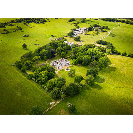 Aerial view of a large Appuldurcombe House estate with a white mansion surrounded by green fields and trees captured by Available Light Photography.