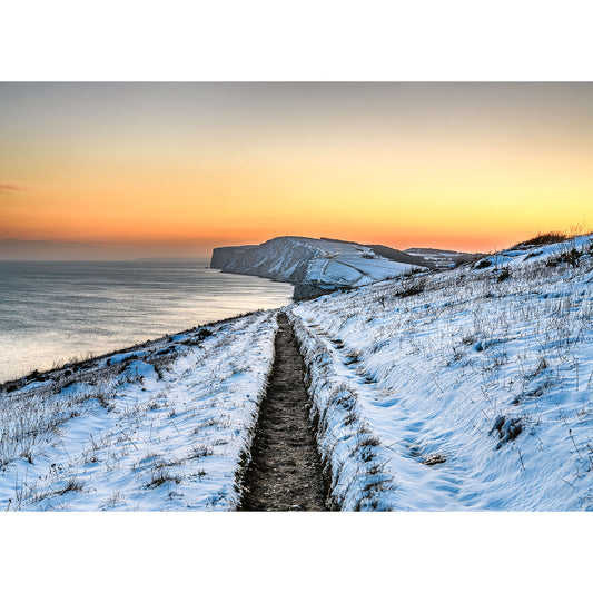 A snowy coastal path leading towards a cliff at sunset on the Isle of Wight captured by Available Light Photography's Tennyson Down.