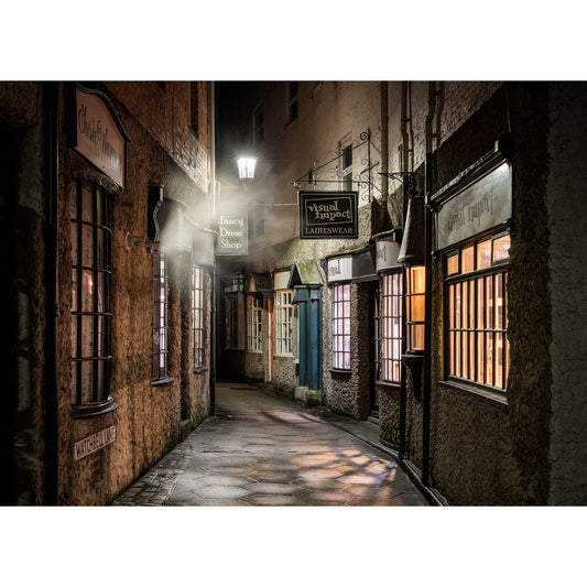 An illuminated narrow alley with Watchbell Lane, Newport storefronts at night.