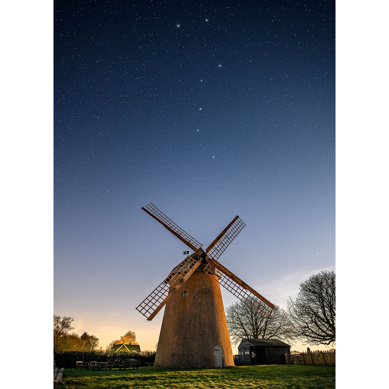A Bembridge Windmill stands against a starry night sky on the Isle of Wight, captured by Available Light Photography.