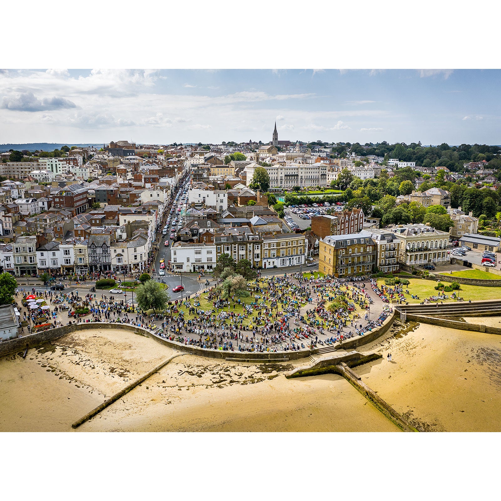 Aerial view of a crowded urban beachfront with a curved promenade from the Scooter Rally, Ryde by Available Light Photography on the Isle of Wight.