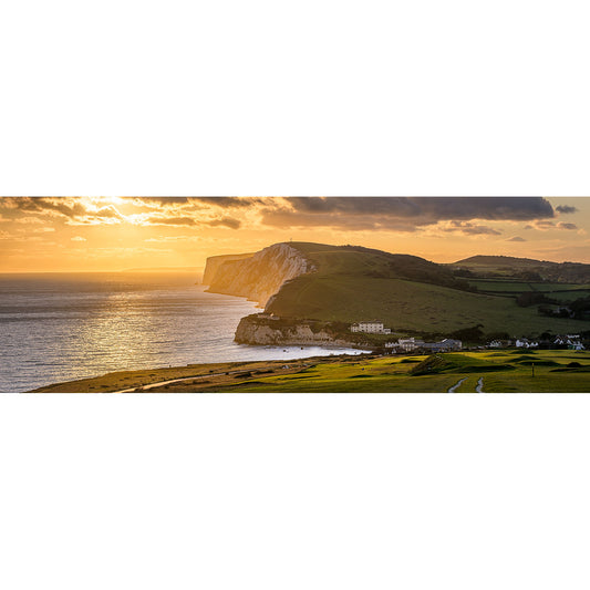 Sunset over a coastal landscape with cliffs and a calm sea on Tennyson Down by Available Light Photography.