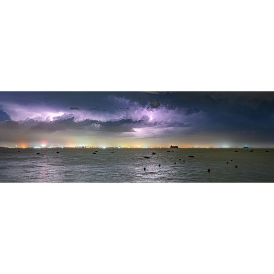 Lightning illuminates clouds above a nighttime seascape dotted with ships near Gascoigne Isle, Wight. - Storm over The Solent by Available Light Photography.