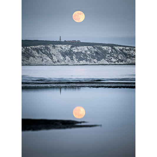 Full Moonrise over Culver Cliff coastal cliffs with reflection on water by Available Light Photography.