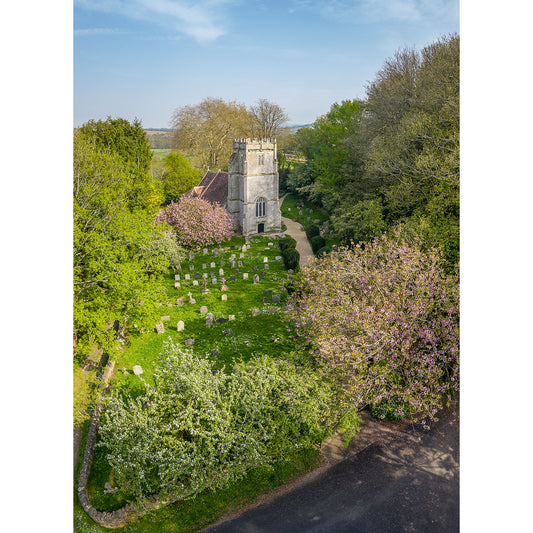 Aerial view of St. Olave's Church, Gatcombe and graveyard on the Isle of Wight, surrounded by trees in bloom, captured by Available Light Photography.
